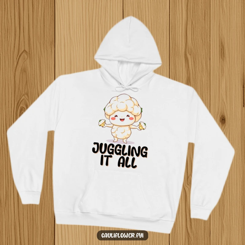Funny hoodie featuring a cheerful cauliflower character balancing three florets in a juggling act, spreading laughter and warmth.