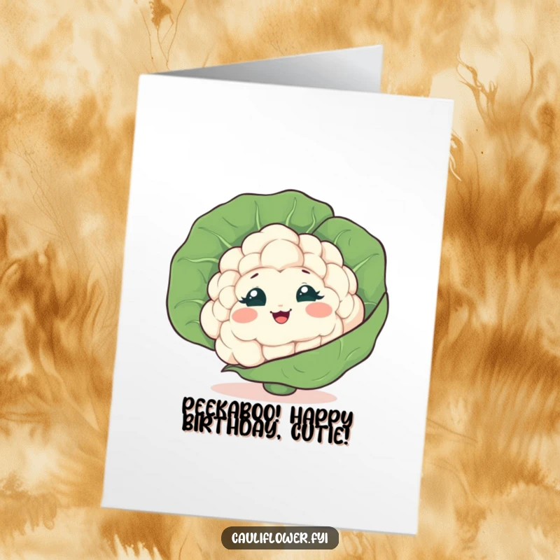 Funny free printable cauliflower head hiding behind a leaf, peeking out and giggling mischievously, perfect for birthdays.